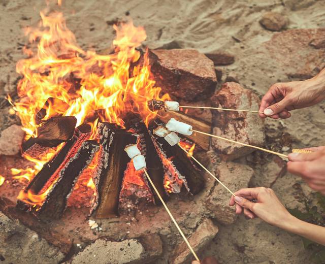 People roast marshmallows over a bonfire on the beach in Lincoln City, OR