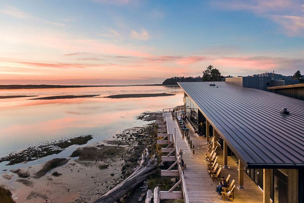 An aerial shot of the sunset along Siletz Bay, showing the outdoor deck of Pelican Brewing.