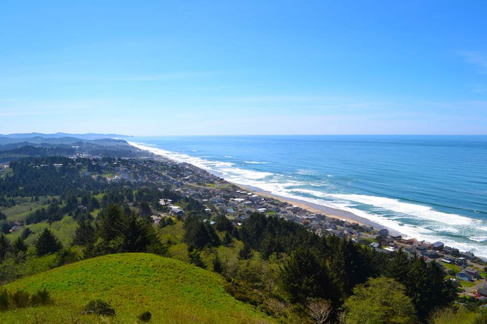 Panoramic view of Lincoln City, OR from The Knoll. Lush green hills roll to the ocean