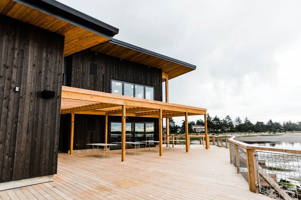 A wooden deck wraps around the exterior of the Pelican Brewing Company in Lincoln City, OR.