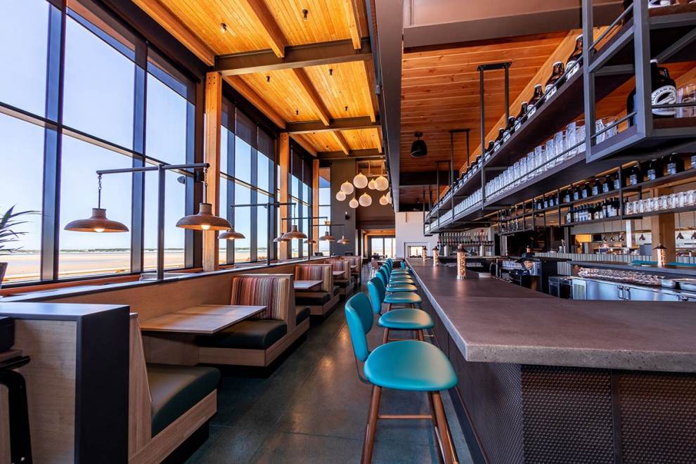 Interior bar and dining room of Pelican Brewing Company in Lincoln City, OR, with turquoise-colored barstools.