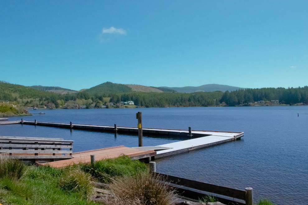 Devils Lake on a sunny day. A dock goes out into the blue lake.