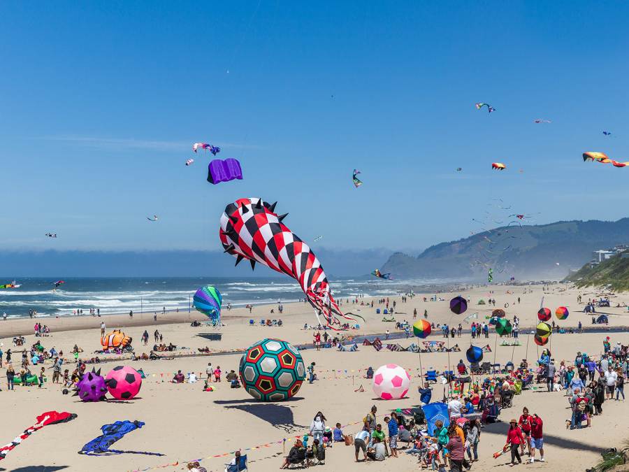 kites fly over the beach at the annual Lincoln City Kite Festival