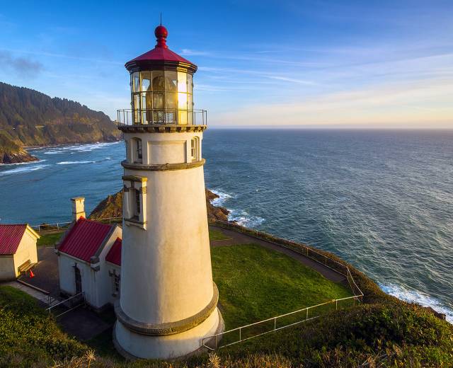 white lighthouse with a red roof on top of cliff along the  Oregon Coast near Lincoln City