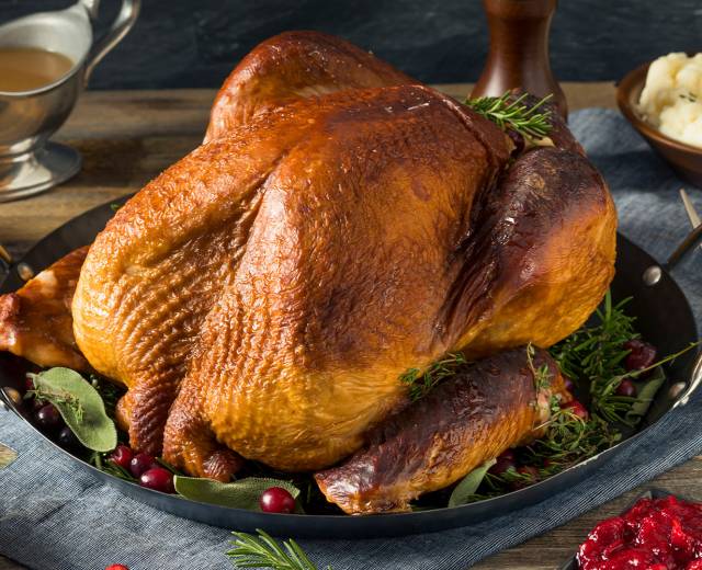 a roast turkey served with cranberries, mashed potatoes, and other sides at Thanksgiving Dinner in Lincoln City, Oregon