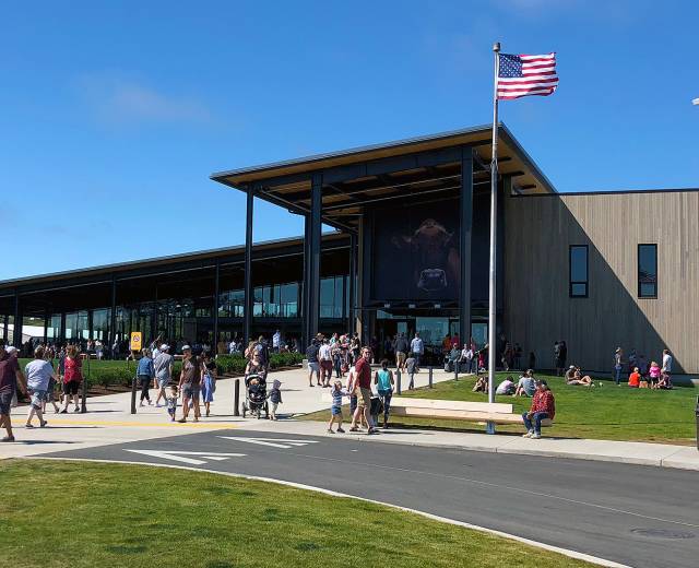 People walk towards the entrance of the Tillamook Creamery.
